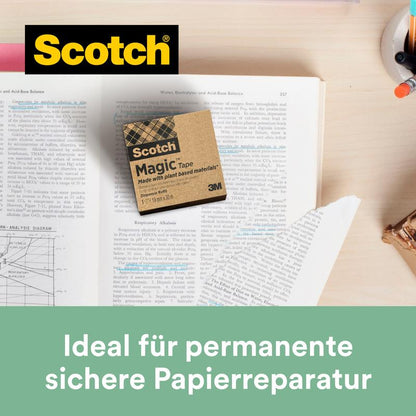 A pack of Scotch® Magic™ Tape from 3M Deutschland GmbH (9 rolls, 19 mm x 33 m, with 66% plant-based adhesive) lies on an open book - ideal for permanent paper repair and sustainable office organization.