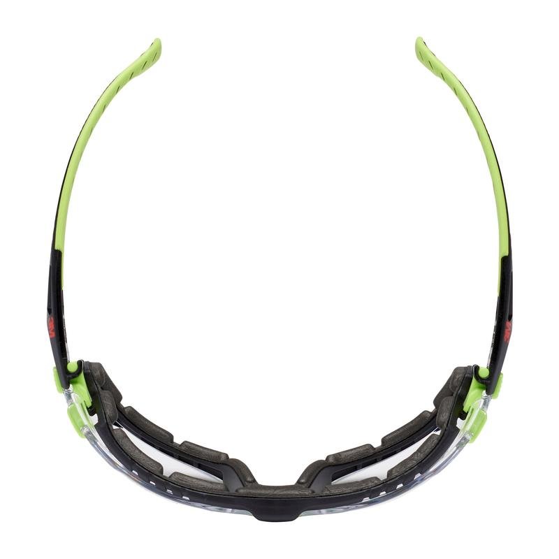 The 3M™ Solus™ Safety Glasses 1000 from 3M Deutschland GmbH feature a clear lens, a black and neon green frame, a cushioned foam gasket, and curved temples. In the top view, the Scotchgard™ coated safety glasses highlight their lining.