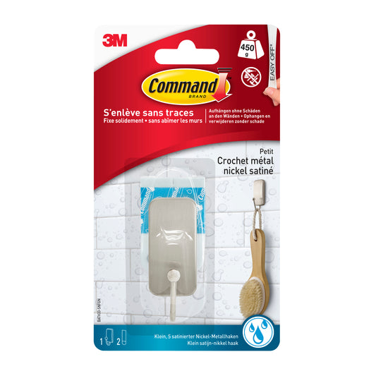 Eine Packung 3M Command™ Metall-Haken Bad, schmal, Satin Nickel, enthält 1 Haken und 25 Klebestreifen. Die Verpackung zeigt den Haken, der eine Bürste als Anwendungsbeispiel hält; hält bis zu 450g. Marke: 3M Deutschland GmbH.