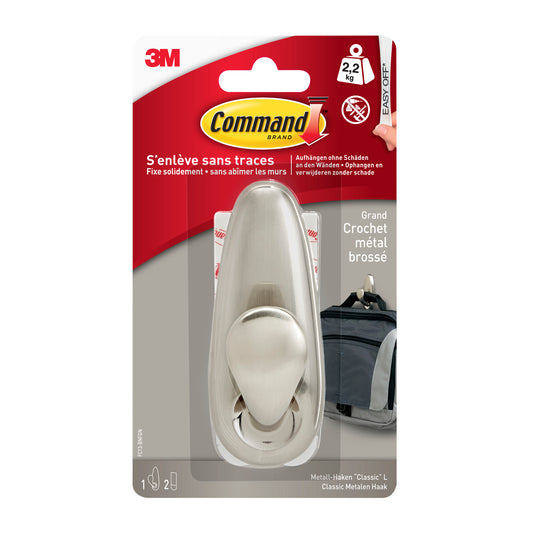 Eine Packung der 3M Deutschland GmbH Command™ Metallhaken "klassisch" trägt bis zu 2,2 kg. Die rot-weiße Verpackung zeigt den Haken, die Befestigungsstreifen und eine Anleitung auf Französisch und Deutsch.