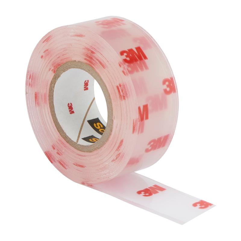 A partially unrolled roll of Scotch-FIX™ Transparent Double-Sided Mounting Tape 4910C from 3M Deutschland GmbH is depicted on a white background, showing the transparent tape with printed red 3M logos.