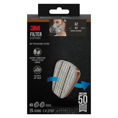 A black packaging of the 3M™ Filter Cartridge 6055, A2 Organic Vapors from 3M Deutschland GmbH, showing a cartridge with a white grid and an arrow for attachment, indicating replaceable filters for organic vapors and mask compatibility.