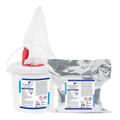 A white plastic bucket with a lid and spout, and a sealed silver pouch, both labeled "Meditrade Medizid® Rapid+ disinfectant wipes" with hazard symbols and the text "quick disinfection" from Meditrade GmbH.